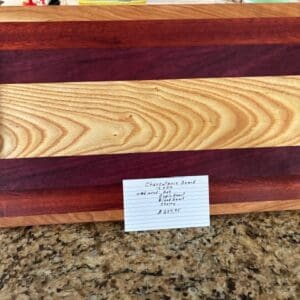 A wooden cutting board with a small label on a countertop.